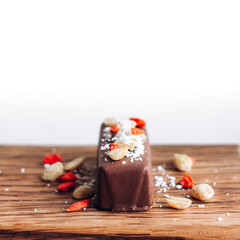 Vegan, gluten free carob chocolate bar with peanuts, goji berries, coconut and healthy micronutrients.