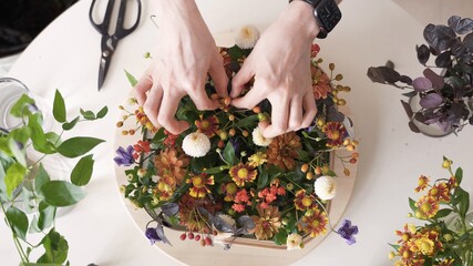 Mujer arreglando una maceta de flores