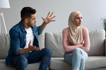 Angry muslim man and woman fighting at home