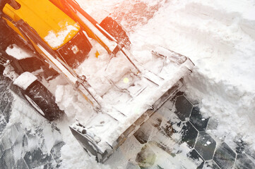 Removing snow accumulations using a tractor with attachments.