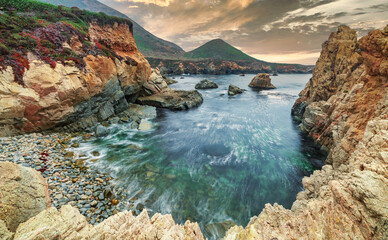 Beautiful view of a small rocky cove in the Pacific Ocean, colorful landscape, sea coast along the...