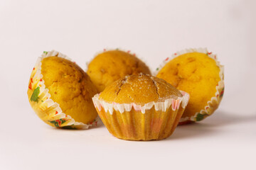 Four cupcakes on a plate on a white background