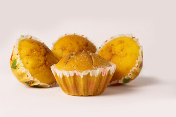 Four cupcakes on a plate on a white background