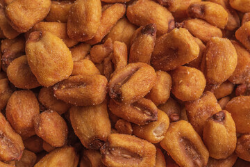 Fried, salted corn grains close-up. Texture of corn nuts. An organic beer snack or savory snack.