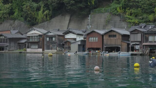 Ripples in Calm Ocean Waters with Fisherman Houses in the Background