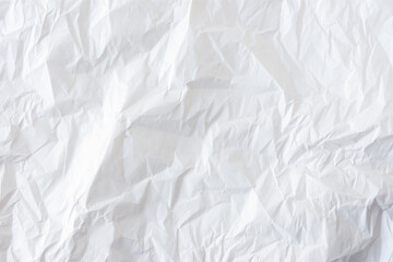White crumpled paper. Abstract textured background made of wrapping paper. A clean crumpled sheet,a layout for the design. Background black and white image. Beautiful paper folds. Eco-friendly product