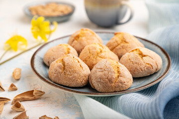 Almond cookies and a cup of coffee on a white concrete background Side view, selective focus.