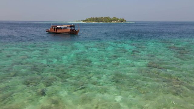 Drone flying past a traditional Maldives Dhonis