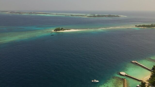 Aerial shot moving over the indian ocean in the maldives