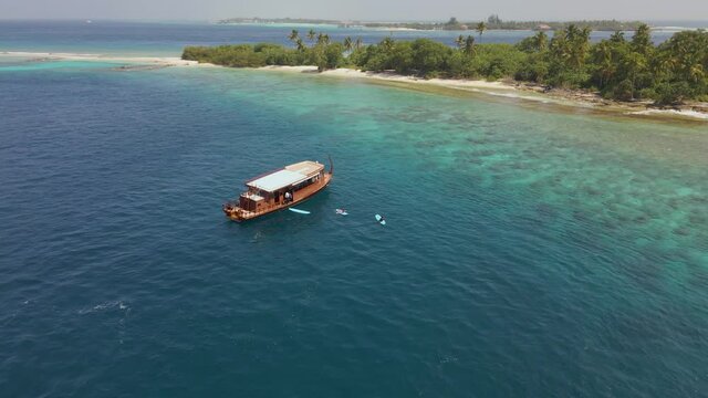 Drone moving backwards on a tropic island in the maldives