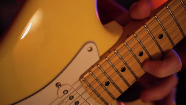 Electric Guitar solo close up. Strat style butterscotch electric guitar