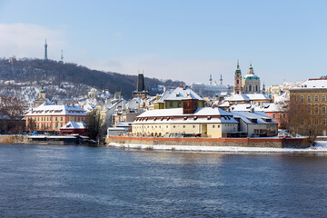 Fototapeta na wymiar Snowy Prague Lesser Town with Prague Castle above River Vltava in the sunny Day , Czech republic