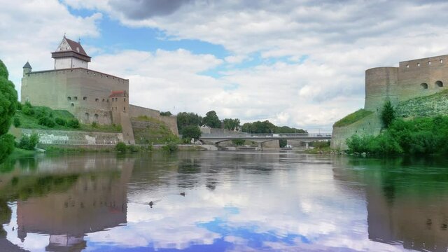 Beautiful city scenery, historic landmarks on Russian Estonian border, Narva Herman castle and Ivangorod fortress on banks of Narva river, cloudy sky skyline