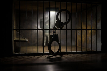 Jail or prison cell. Man in prison man behind bars concept. Old dirty grunge prison miniature. Dark...