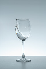 Splash of water in a glass on a gray background