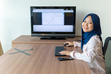 Malay lady using laptop at home