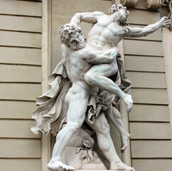A statue depicting the ancient Greek hero Hercules and his exploits. Sculpture on the facade of a...