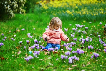 Cute little girl playing egg hunt on Easter