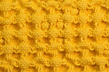 Detailed closeup of yellow terry towel texture 