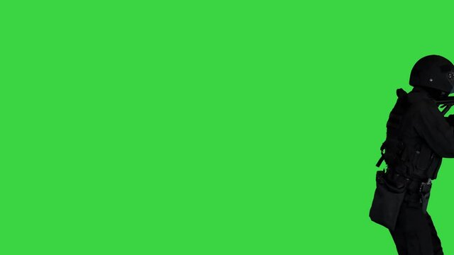Anti terrorist unit policeman walking and aiming with a rifle on a Green Screen, Chroma Key.