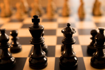 Black queen and king wooden chess board initial strategy start of the game