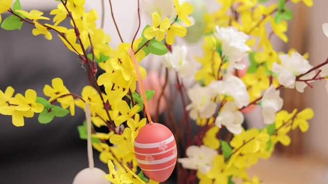 Beautiful Easter decoration with Easter eggs on a buch of flowers - Happy Easter