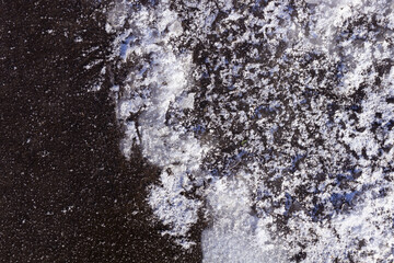 a frozen puddle with snow and an air cavity that was opened