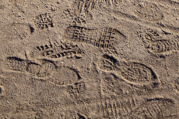chaotic footprints of man's shoes in the sand