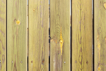 unpainted wooden fence with small gaps