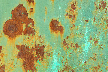 blue wall with rust spots showing through the paint