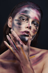 Beautiful portrait of woman with drawing paint on the face and body