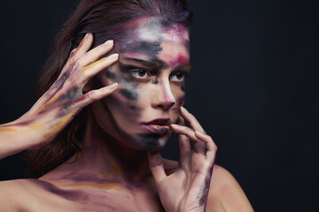 Beautiful portrait of woman with drawing paint on the face and body