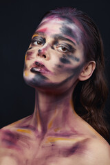 Beautiful portrait of woman with drawing paint on the face and body