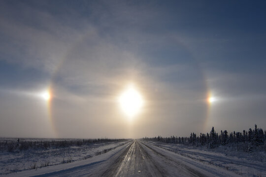 Ice crystals in the atmosphere create a halo around the sun with sun dogs to the left and right.
