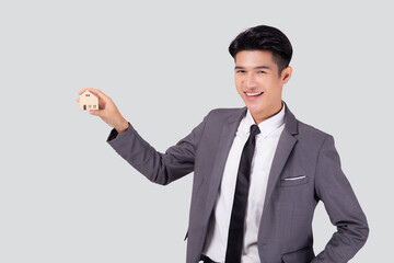 Young asian business man holding the home symbol of saving for future, insurance agent and credit, ownership house, debt and loan of finance, purchase home and refinance, investment real property.