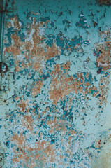 Old plywood with cracked peeling blue paint, vintage background, outdoor weathered material. Close-up
