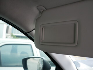 closeup of sun visor with mirror in a car.
