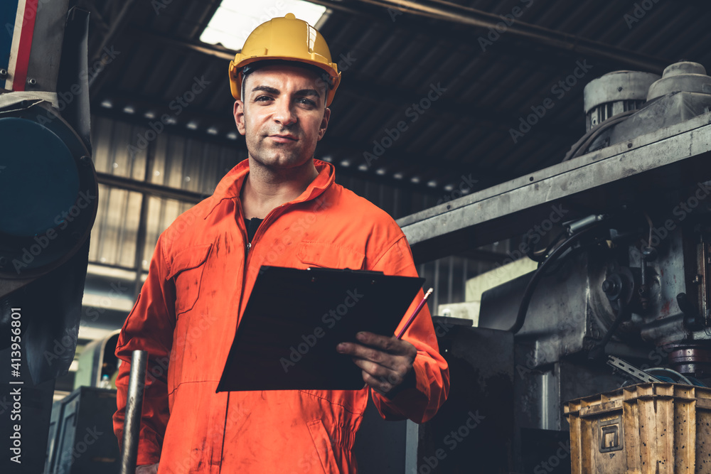 Poster skillful factory worker working with clipboard to do job procedure checklist . factory production li