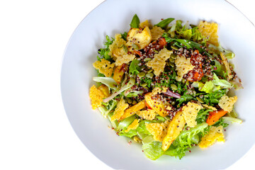 A salad with romaine lettuce cheese cracker and different seeds.