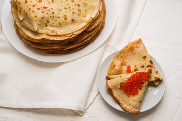 thin pancakes with red caviar on white napkin. The concept of the Russian carnival Maslenitsa
