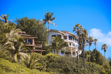 Fototapeten Houses and palm trees on a cliff by the sea at Spitting Cave， East Honolulu Coast Oahu Hawaii.  © youli