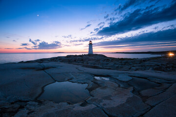 The Peggy's Cove Lighthouse landscape along the rugged rocks of the Atlantic Coast Nova Scotia Canada. The most visited tourist location in the Atlantic Canada and famous Lighthouse captured with vibr