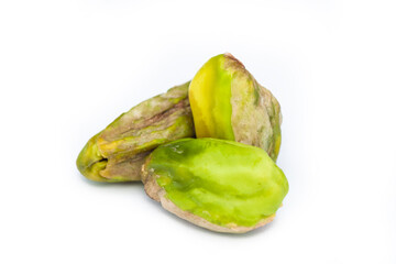 three peeled pistachio nuts isolated on white background