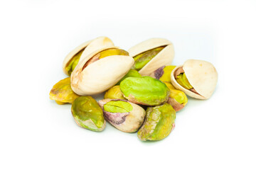Peeled and unpeeled pistachio nuts isolated on white background