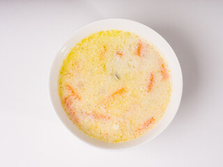 Cheese soup in a white round bowl. Studio photo on white background