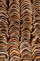 Old terracotta tile stacked in piles background