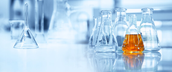 flask and glassware equipment in chemistry science laboratory banner background.