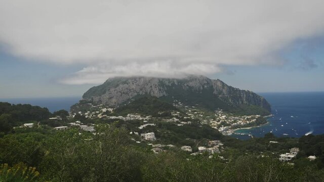 Aerial view of the mountain above Capri with clouds covering the summit.