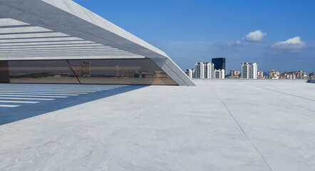 Perspective view of empty concrete floor and modern rooftop building