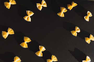 Farfalle pasta on black background with text space